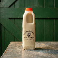 Wayside Farm fresh raw Jersey milk on a zinc table